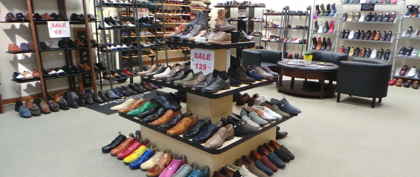 Inside Alligator World, tiered displays of exotic skin dress shoes with walls of shoes behind them