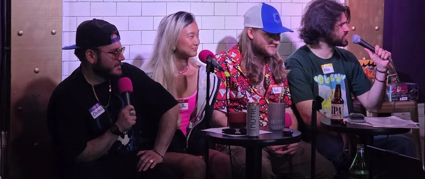 The Brotaku crew on stage with microphones at EastVille Comedy Club