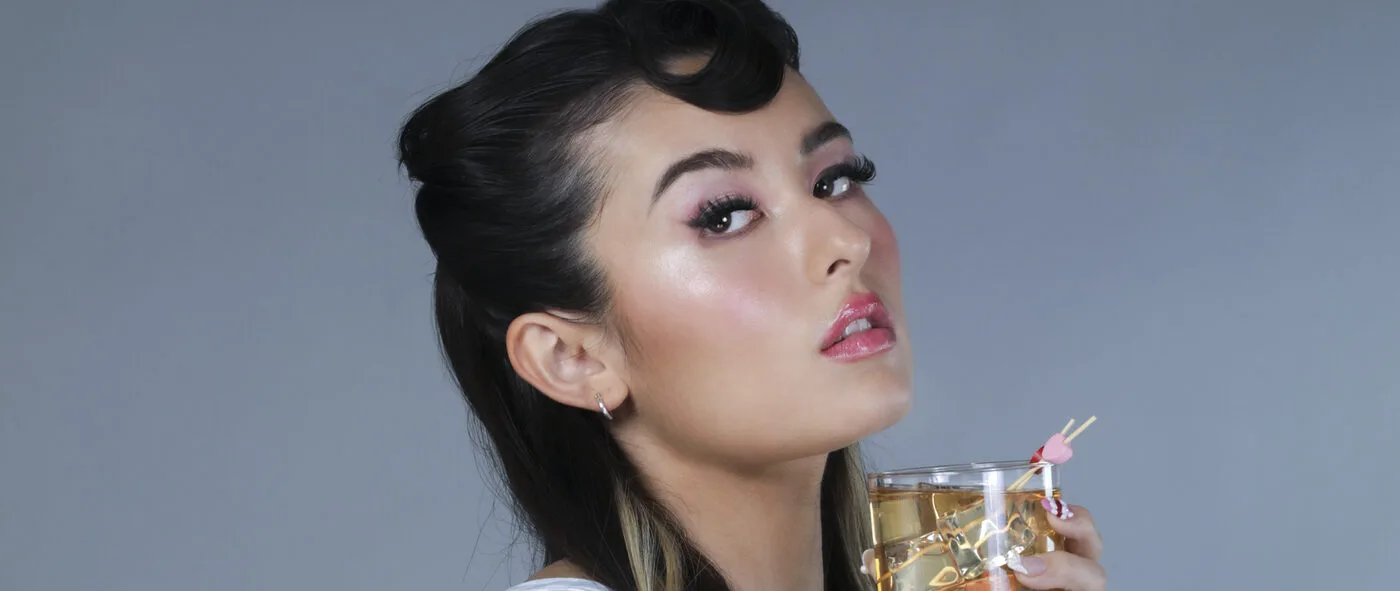 ChiChi (Cecilia Gault) holding a cocktail in a studio portrait
