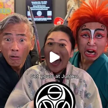 Three Samurai Sword Soul performers pulling wide-eyed faces at the camera, one in red-haired oni makeup, a woman in a pale kimono between them.